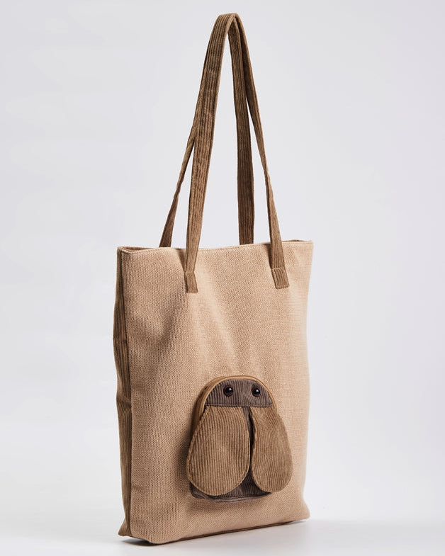 Three-quarter view of the beige Fly tote bag